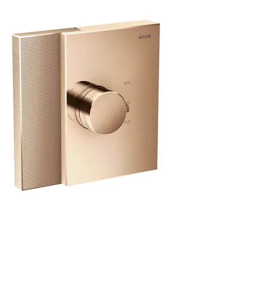 Thermostat von AXOR in poliertem Rotgold, rechteckige Form mit einem zentralen Drehregler zur Einstellung von heißem und kaltem Wasser.